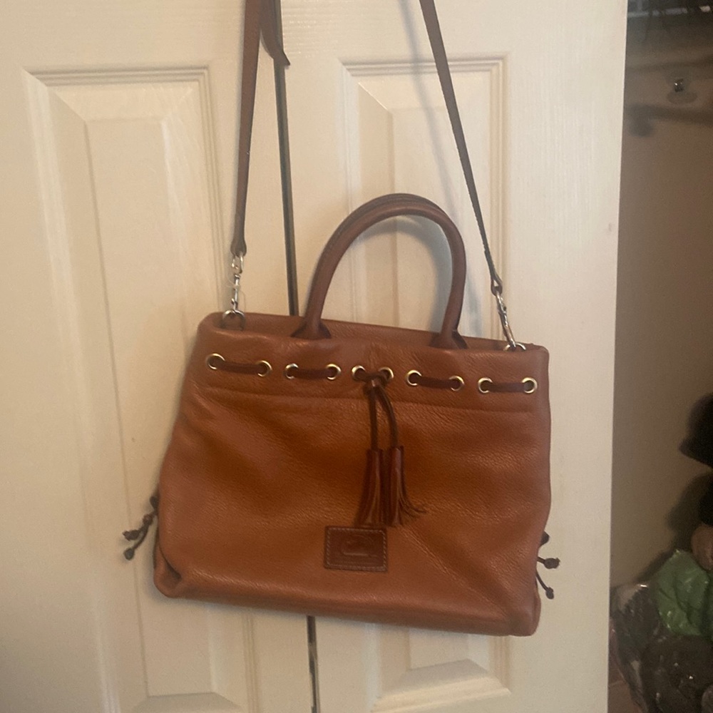 Dooney and Bourke Carmel colored cross body with brown and gold details.